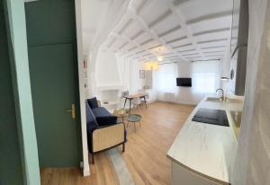 a room with a kitchen and a living room at Le 101 - Les Locations ISAHORA in Eu