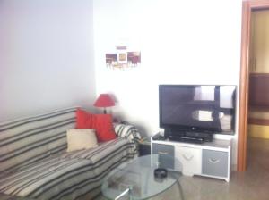 a living room with a couch and a tv at 3 Bed Apt loc Marinella Pizzo Vv 89812 Calabria, Southern Italy in Casa Carrieri