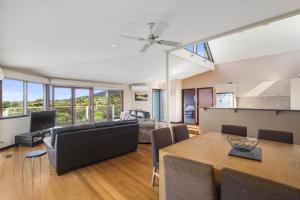 a living room and dining room with a table and chairs at Swingbridge in Lorne
