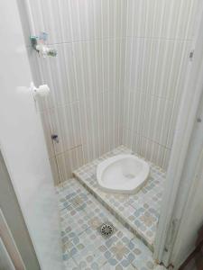 a bathroom with a toilet in a stall at Shinta Syariah Homestay Dieng RedPartner in Dieng
