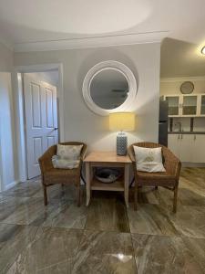 a dining room with a table and two chairs at Patonga Street Retreat in Patonga