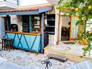 a bar with a dog sitting in front of it at Çınarlar Apart Hotel KAŞ in Kaş