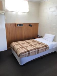 
a hotel room with a bed and a desk at Glossop Motel in Winkie
