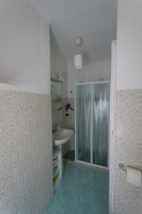 a bathroom with a sink and a glass shower at Casa RoSiLù in Monopoli