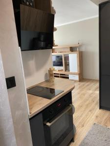 a kitchen with a stove and a counter top at D&N Apartments Синеморец in Sinemorets