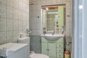 Un baño con lavabo, inodoro y espejo. en Apartment Nikola, en Poreč