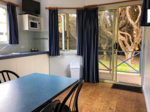 a kitchen with a table and chairs and a window at Tasman Holiday Parks - Yallingup Beach in Yallingup