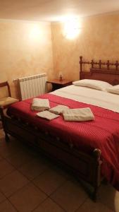 a bedroom with a bed with two towels on it at Casa Valmontone in Valmontone
