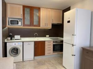a kitchen with a white refrigerator and a dishwasher at Apartamento Veradulce, Vera Playa in Vera