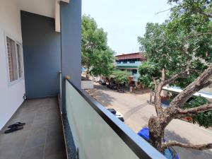 a balcony with a tree on the side of a building at Meer Stay - Premium Service Apartments in Vānivilāsa Puram +5 photos