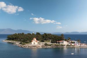 a small island with a church in the middle of the water at The Olive Yard in Gythio