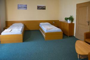 Postel nebo postele na pokoji v ubytování Apartmány Přízámčí