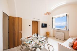 a living room with a table and a window at Lemon in the air Family in Pontone