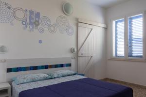 A bed or beds in a room at Locanda Villa Fiori