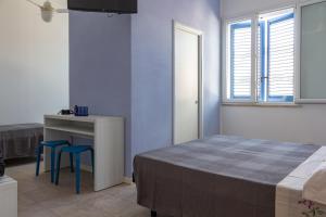 A bed or beds in a room at Locanda Villa Fiori