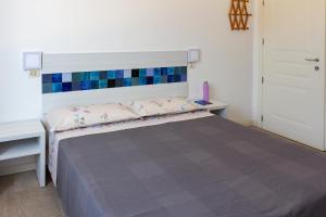 A bed or beds in a room at Locanda Villa Fiori