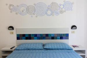 A bed or beds in a room at Locanda Villa Fiori