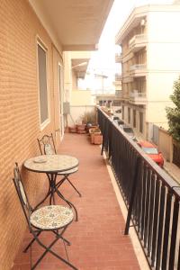 un patio con 2 tavoli e sedie su un balcone di Dolce Rita a Galatina
