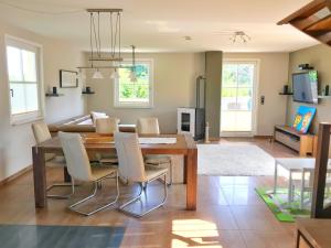 a dining room and living room with a table and chairs at Ferienhaus Sarcander in Glowe