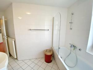 a white bathroom with a shower and a tub at Appartements am Rondell Neddesitz, Appartement 305 in Neddesitz