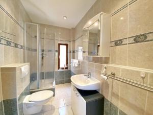 a bathroom with a toilet and a sink and a shower at Ferienwohnungen Stadtmitte in Sassnitz +9 photos