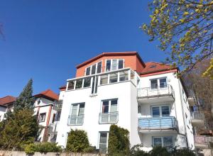 biały budynek z czerwonym dachem w obiekcie Sassnitz Villa Tizian Wohnung 9 RZV w mieście Sassnitz
