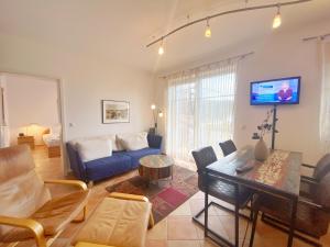 a living room with a couch and a table at Sassnitz Villa Tizian Wohnung 9 RZV in Sassnitz
