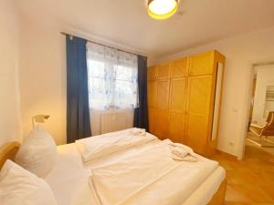 a bedroom with a white bed and a window at Sassnitz Villa Tizian Wohnung 9 RZV in Sassnitz