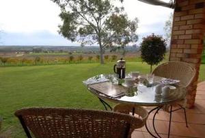 a person sitting at a table with a table cloth at Blickinstal Barossa Valley Accommodation in Bethany