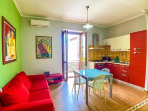 Una sala de estar con un sofá rojo y una mesa. en New Alguerhouse, en Alghero 23 fotos más
