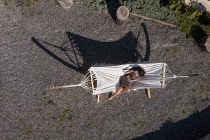 a person sitting on a chair with an umbrella at The Olive Yard in Gythio