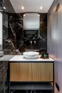 a bathroom with a sink and a mirror at The Newel Acropolis in Athens