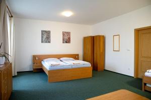 Postel nebo postele na pokoji v ubytování Apartmány Přízámčí