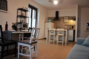 a kitchen and living room with a table and chairs at Il Giardino delle Erbe in Badia