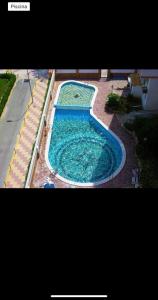 a large pool of water in a yard at Primera línea en Cullera con piscina. Inmejorables vistas in Cullera