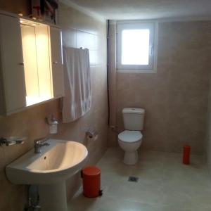 a bathroom with a sink and a toilet and a window at VILLA S&A MEDITATION in Chalkida