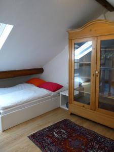 a bedroom with a bed and a wooden cabinet at Ferienhaus Barbarasegen in Altlay