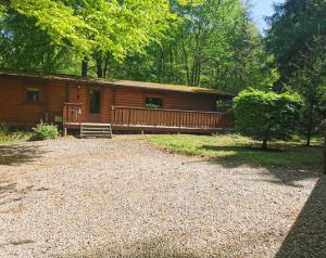 a cabin in the woods with a gravel driveway at Fern Lodge in Louth