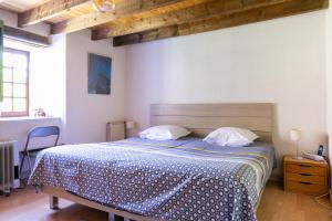 a bedroom with a bed with a wooden headboard at Château de Laulagnet in Jaujac +10 photos