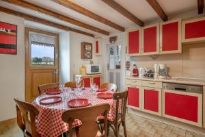 a kitchen with a table with red plates on it at Golfe du Morbihan, Maison de charme pour 6 in Sarzeau