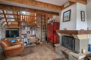 a living room with a fireplace and a red refrigerator at Golfe du Morbihan, Maison de charme pour 6 in Sarzeau