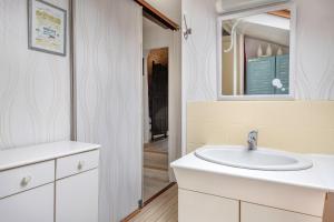 a bathroom with a sink and a mirror at Golfe du Morbihan, Maison de charme pour 6 in Sarzeau +15 photos