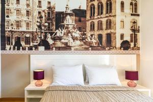 a bedroom with a poster of a fountain and buildings at Riva City Rooms in Split