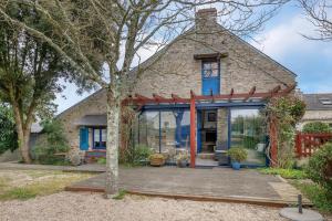 a stone house with a deck in front of it at Golfe du Morbihan, Maison de charme pour 6 in Sarzeau