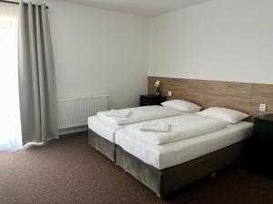 Postel nebo postele na pokoji v ubytování Motel R10