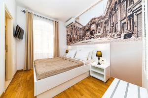a bedroom with a bed with a drawing on the wall at Riva City Rooms in Split