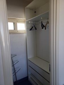 a walk in closet with a shelf and hangers at Casa Vacanza in Torre San Giovanni Ugento
