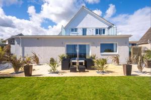 a white house with a lawn in front of it at Crail 5 Bedroom Villa in Crail