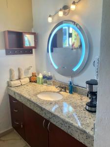 a bathroom with a sink and a large mirror at Casa Mi Tesoro in Playa del Carmen