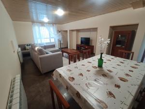a living room with a table with a wine bottle on it at CASA ISAURA DE PENA Camino Primitivo in Pacio